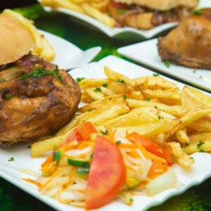 Savory roast chicken with crispy fries and fresh salad on a white plate.